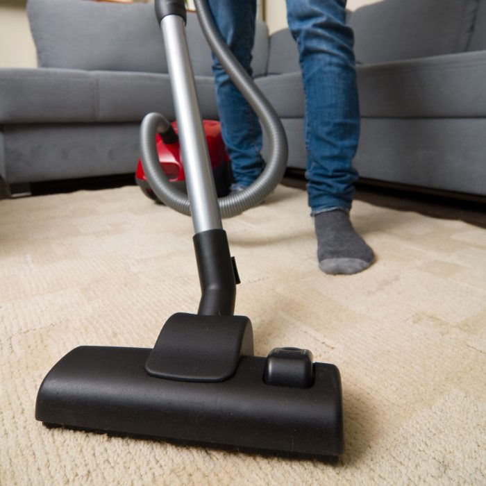 cleaning home with vacuum cleaner