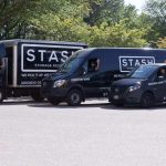 three sizes of stash storage moving vans and trucks with drivers waving from vehicles